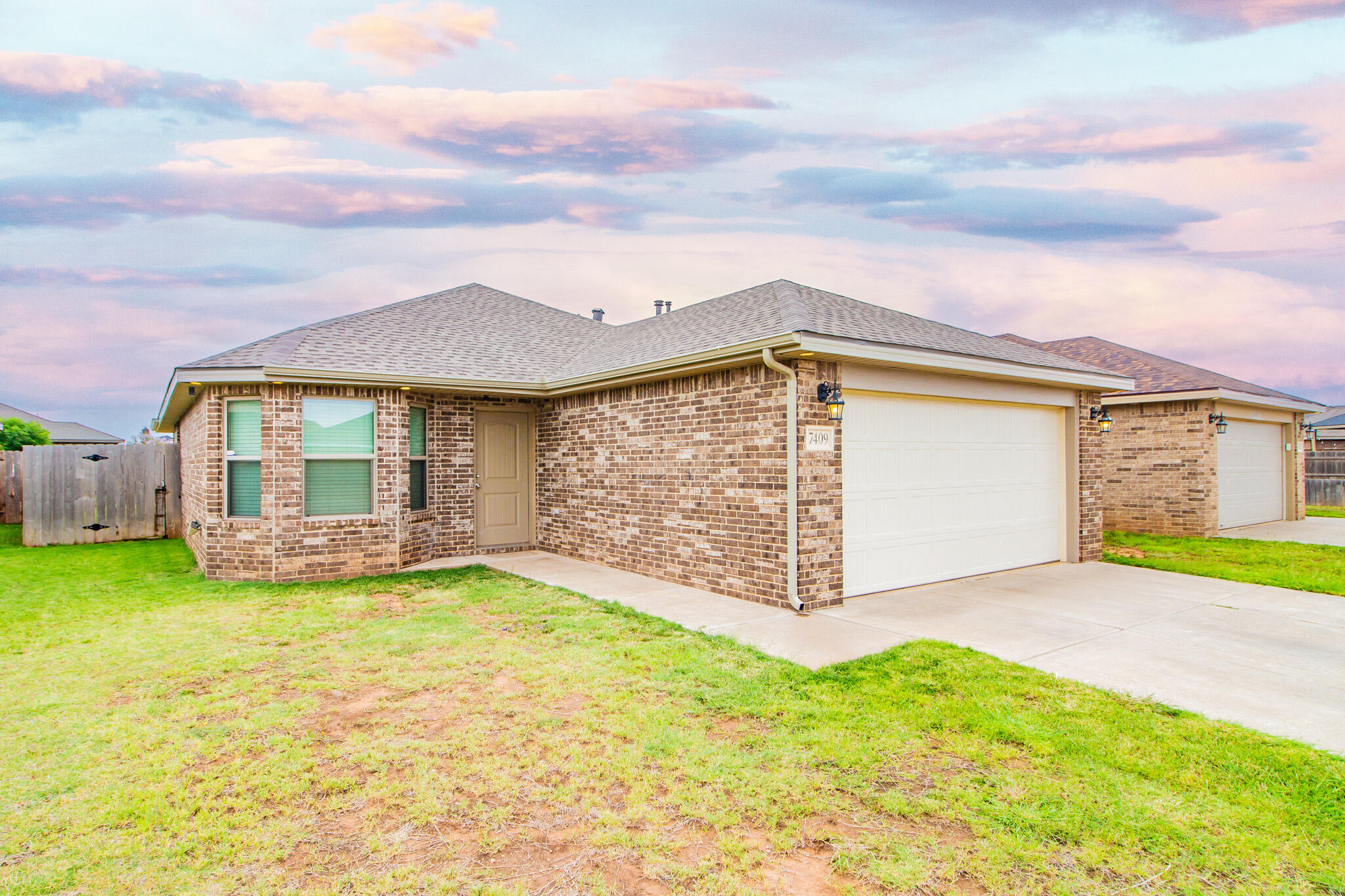 7409 101st Street Lubbock, TX 79424 - Photo 1 of 22 a view of a house with a garden and yard
