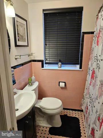 a bathroom with a toilet and a sink