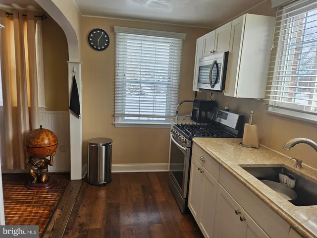 a kitchen with a sink cabinets and window