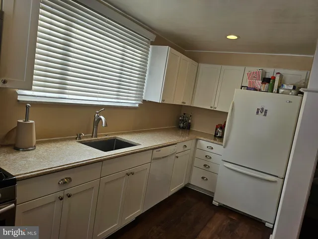 a kitchen with sink and cabinets