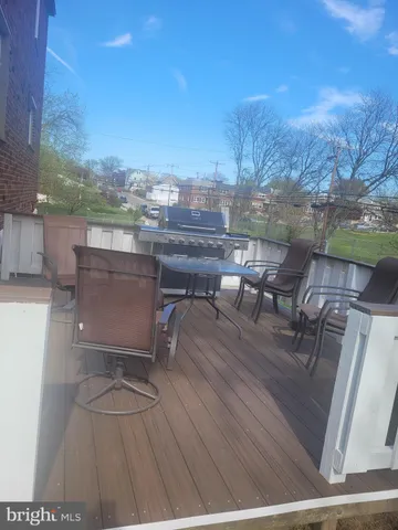 a view of a terrace with furniture and a yard