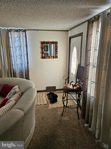 a living room with furniture and a mirror