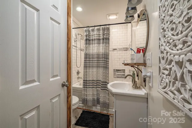 a bathroom with a sink a mirror and a shower