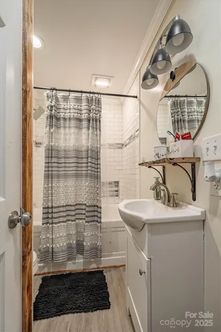 a bathroom with a sink a mirror and a shower