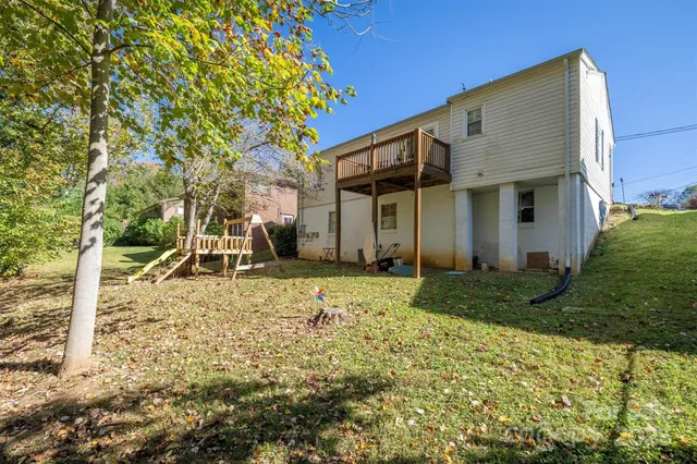 a backyard of a house with barbeque oven table and chairs
