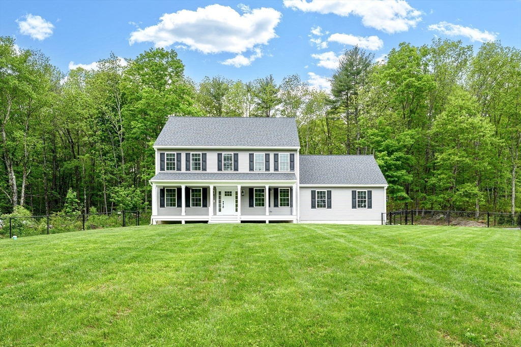 1310 North Brookfield Road Oakham, MA 01068 - Photo 2 of 30 a front view of a house with a garden