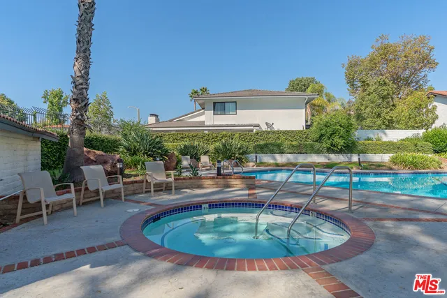 a swimming pool with outdoor seating and yard