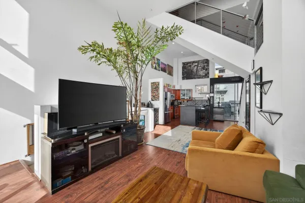 a living room with furniture a rug and a book shelf