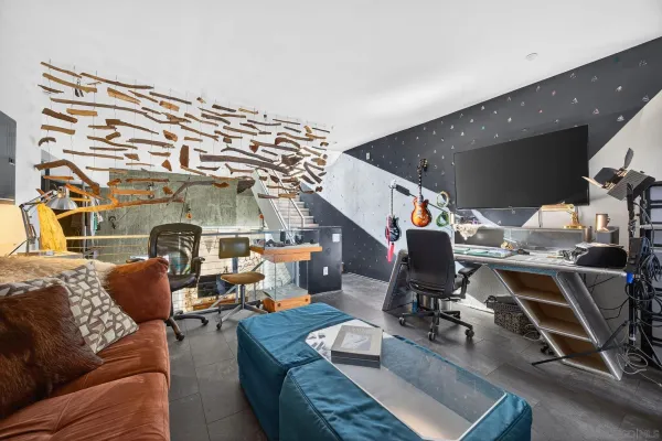 a living room with furniture and a floor to ceiling window
