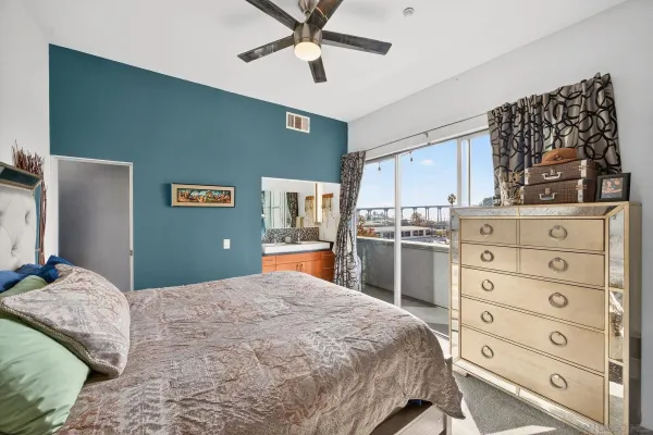 a bedroom with a bed and a dresser
