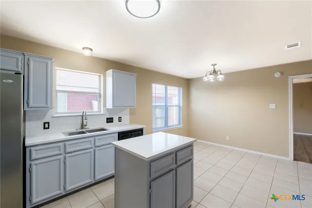 a kitchen with a sink cabinets and window