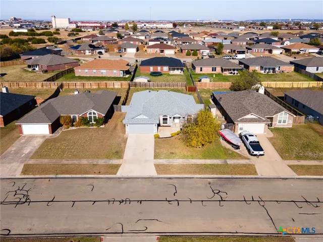 an aerial view of residential houses with outdoor space
