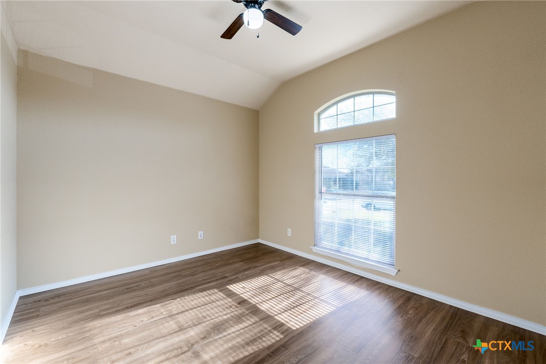 4701 Neta Drive Killeen, TX 76549 - Photo 22 of 28 an empty room with wooden floor fan and windows
