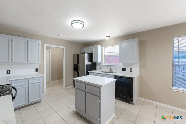 a kitchen with a sink stove and cabinets