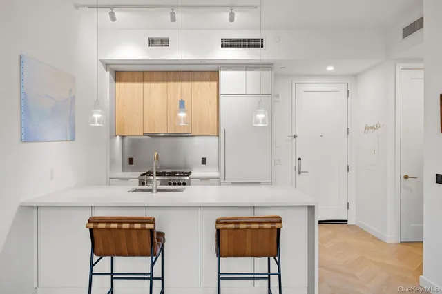 a kitchen with a appliances a sink and a refrigerator
