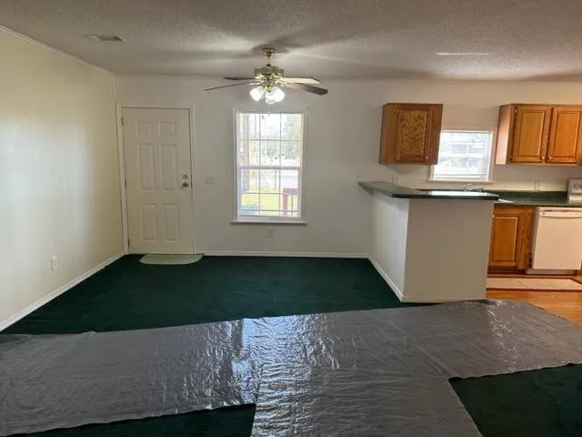 a living room with kitchen island granite countertop furniture and a fireplace