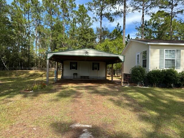60 Magnolia Court Freeport, FL 32439 - Photo 22 of 29 a view of a house with a yard and tree s