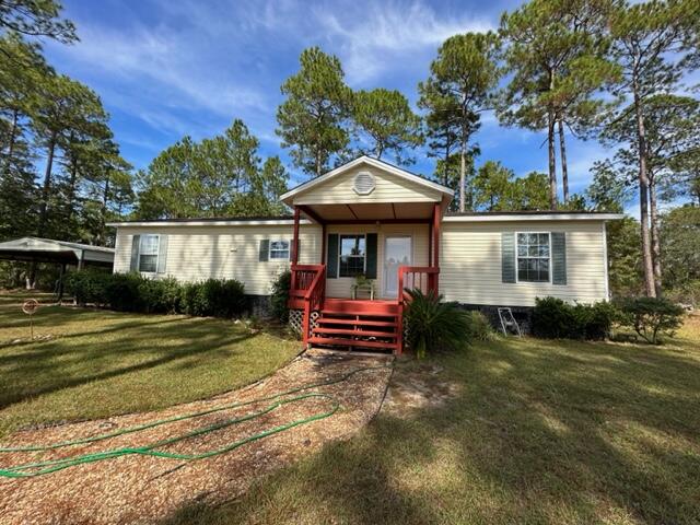 60 Magnolia Court Freeport, FL 32439 - Photo 25 of 29 a front view of a house with garden
