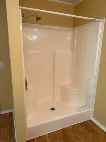 a bathroom with a glass shower door