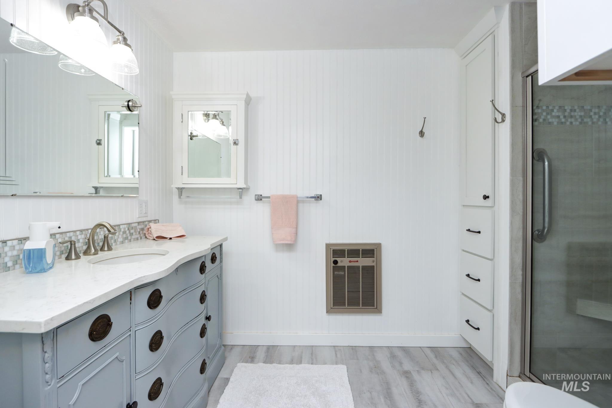 2528 Waterwheel Road Emmett, ID 83617 - Photo 18 of 50 Spacious bedroom featuring wood-finish flooring, a ceiling fan, and white paneled bi-fold closet doors