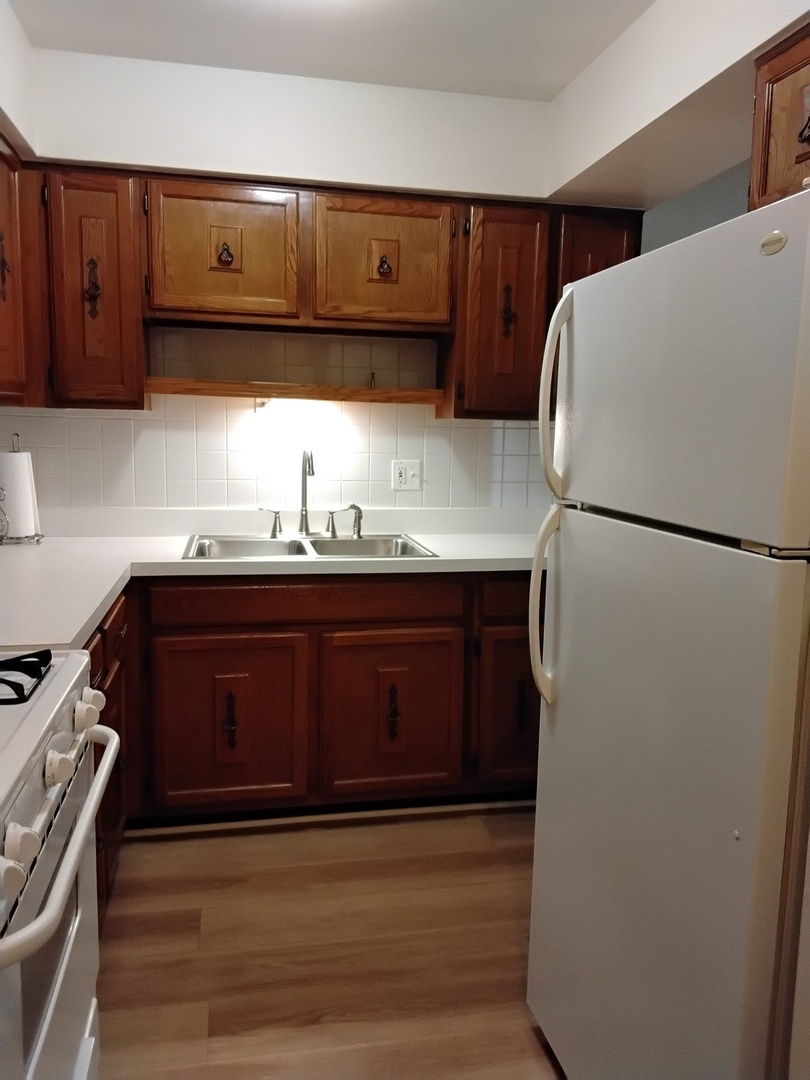 12721 Park Place, Unit 2B Crestwood, IL 60418 - Photo 4 of 12 a kitchen with a sink and a refrigerator