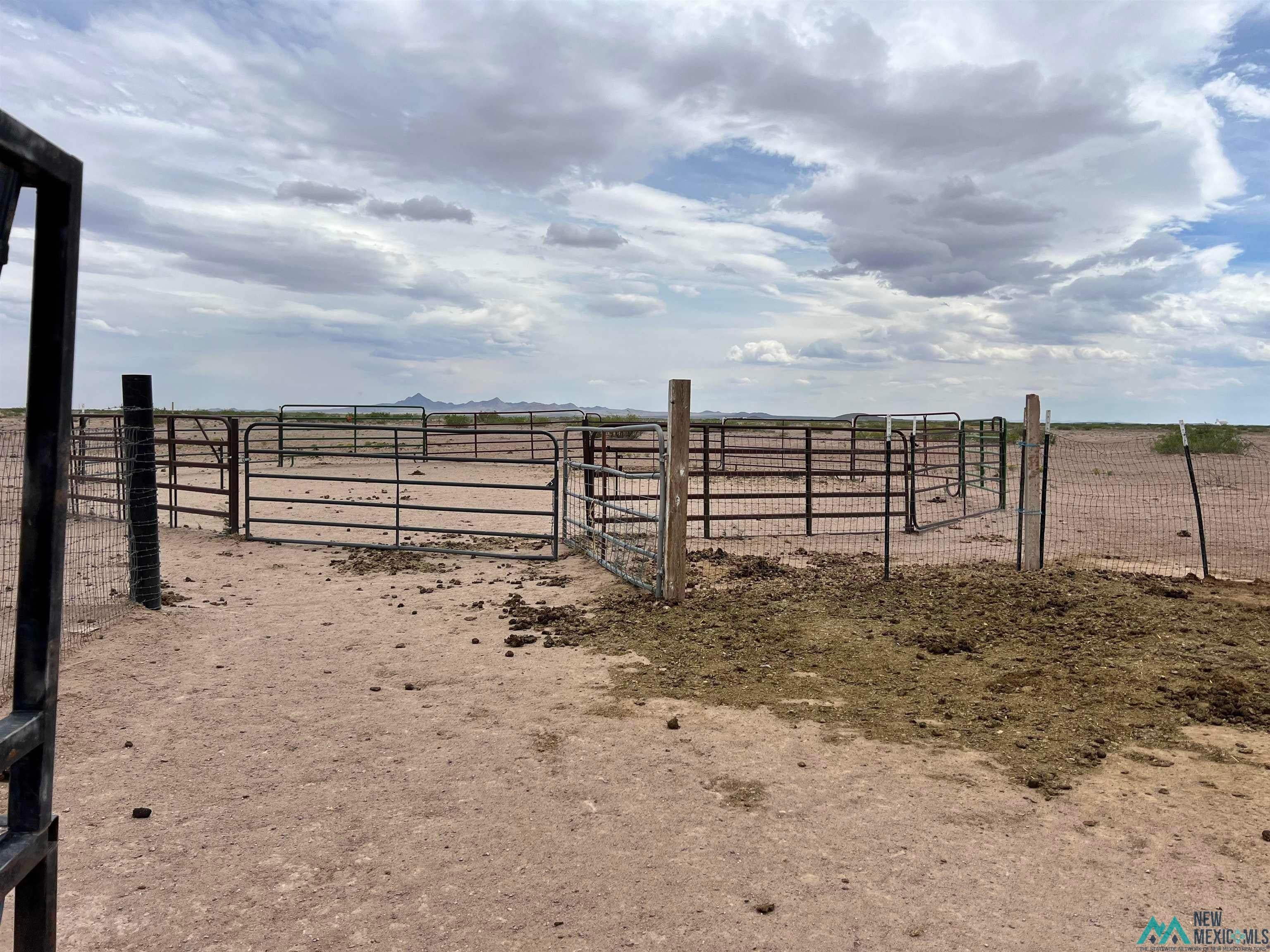 14006 Ciguena Road Southwest Deming, NM 88030 - Photo 42 of 49 View of yard with an outbuilding, an exterior structure, and a view of countryside