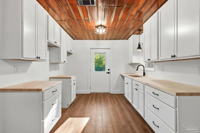 a kitchen with a sink window and cabinets