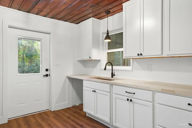 a kitchen with a sink cabinets and a window