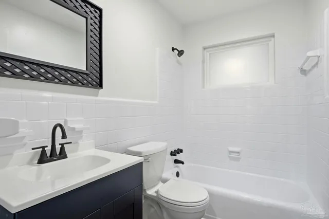 a bathroom with a sink toilet a mirror and shower