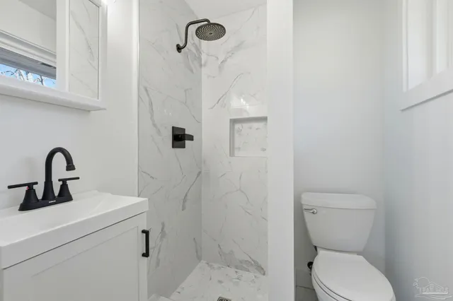 a bathroom with a toilet sink and a shower