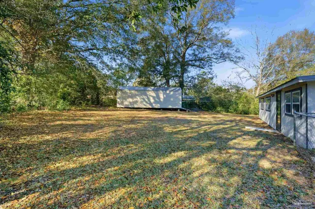 a view of a yard with a tree