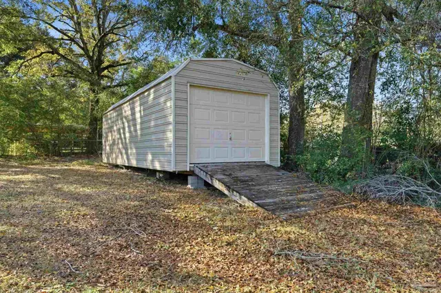 a backyard of house with a trees