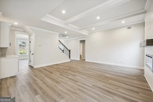 a kitchen with stainless steel appliances kitchen island a sink a stove and a window