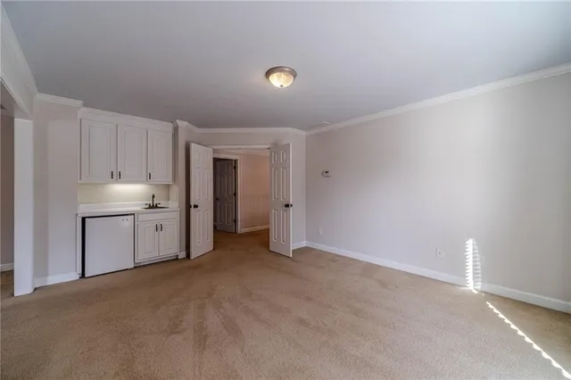 a kitchen with stainless steel appliances granite countertop a sink and a refrigerator