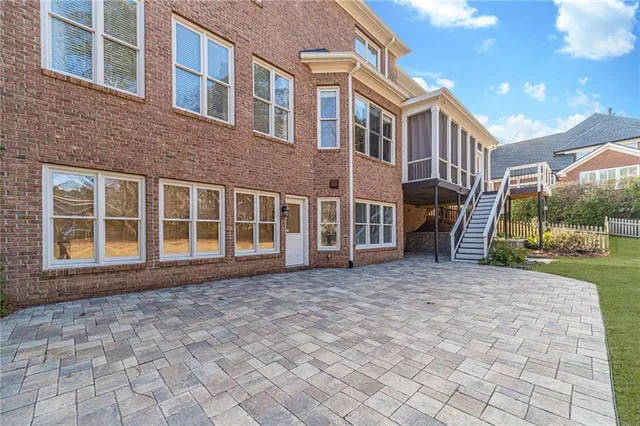 a view of a livingroom with a chandelier fan and windows