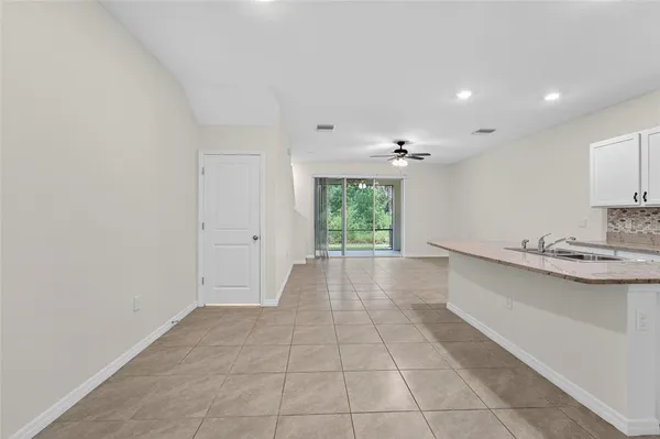 a kitchen with a sink a stove a microwave and a refrigerator