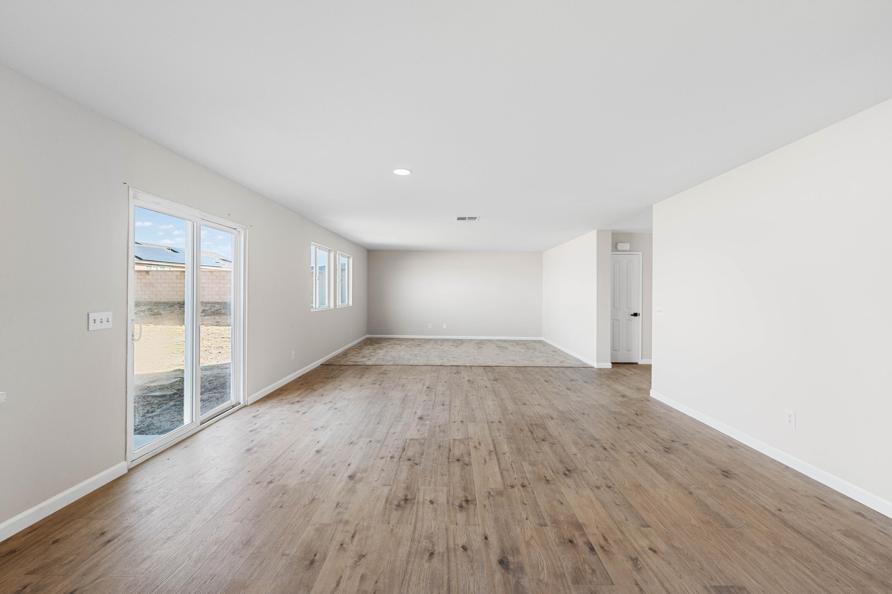 42570 72nd Street West Lancaster, CA 93536 - Photo 11 of 43 an empty room with wooden floor and windows