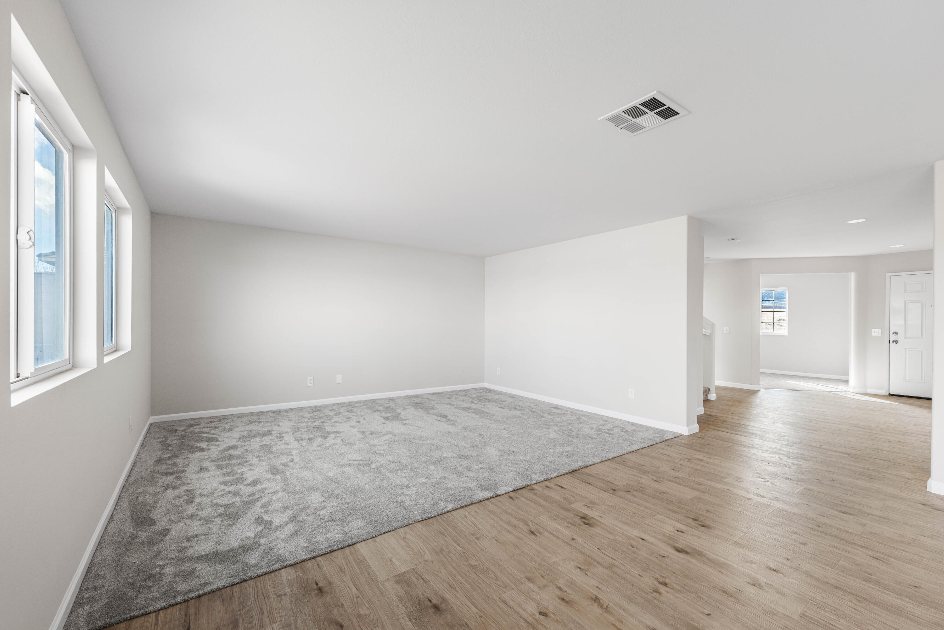 42570 72nd Street West Lancaster, CA 93536 - Photo 6 of 43 an empty room with wooden floor and windows