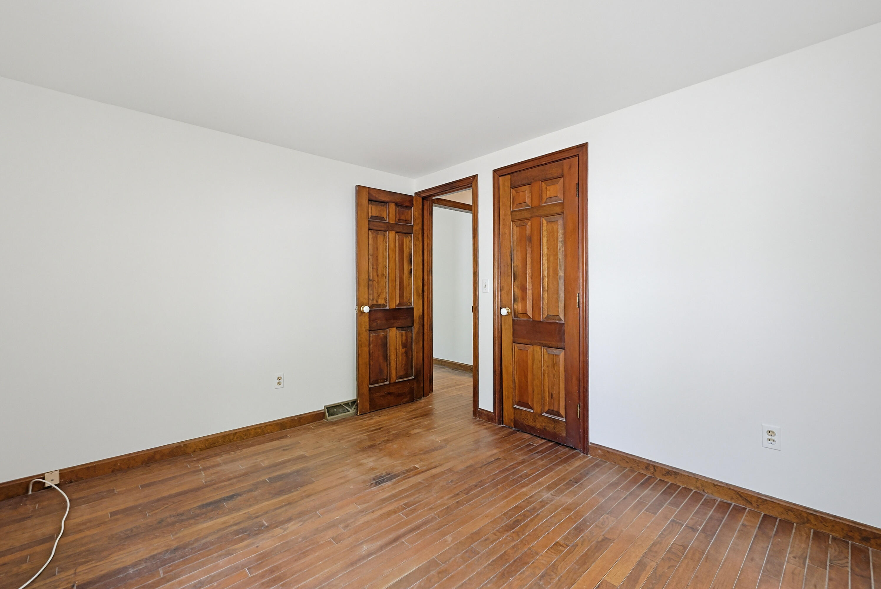 556 Cotuit Road Mashpee, MA 02649 - Photo 12 of 45 an empty room with wooden floor and closet