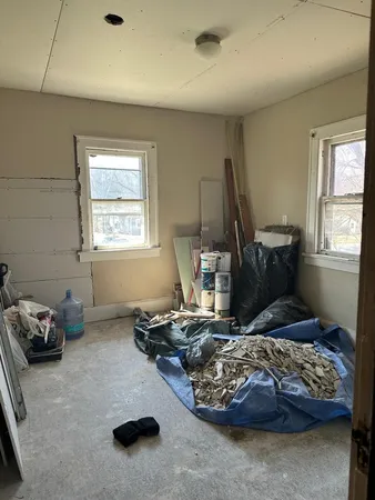 a bedroom with furniture and a window