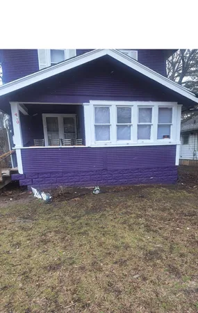 a view of a house with wooden fence