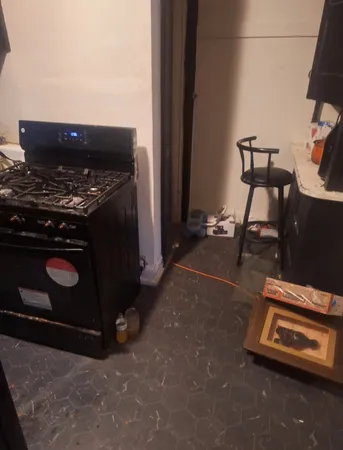 a stove top oven sitting inside of a kitchen