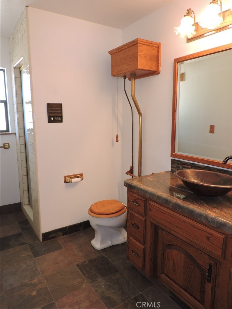 26931 Columbia Way Tehachapi, CA 93561 - Photo 42 of 49 Hallway / Guest Bathroom has a fun "Old Timey" toilet! Cool Copper sink and plenty of counter space.