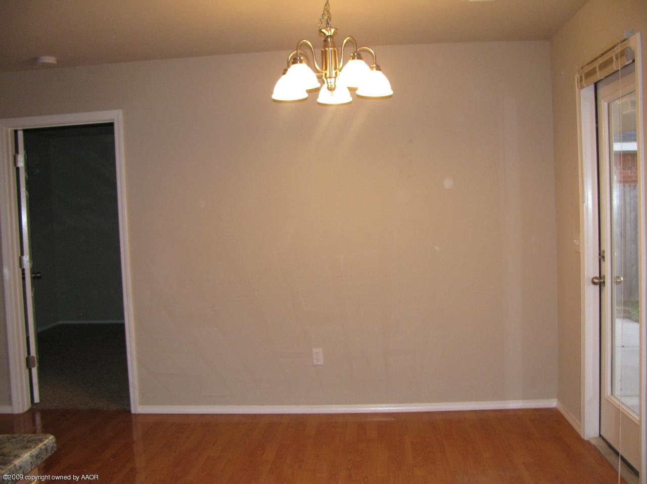 4816 Mammoth Lane Amarillo, TX 79110 - Photo 3 of 9 a room with wooden floor and windows