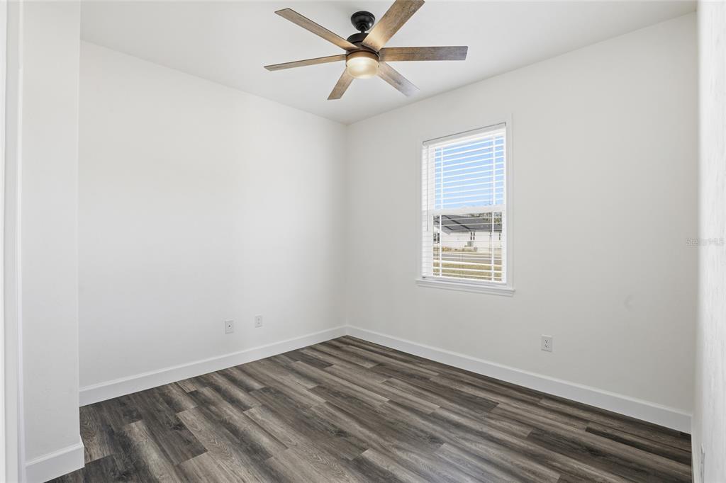 24302 Southwest 18th Road Newberry, FL 32669 - Photo 15 of 30 an empty room with a window and a ceiling fan