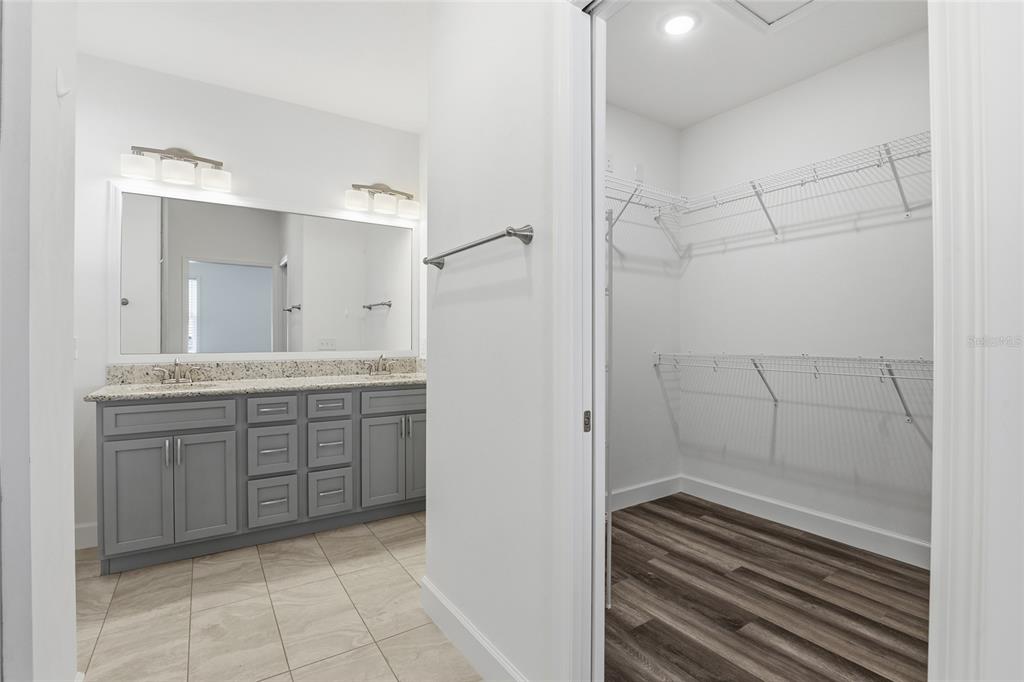 24302 Southwest 18th Road Newberry, FL 32669 - Photo 17 of 30 a bathroom with a granite countertop sink mirror and shower