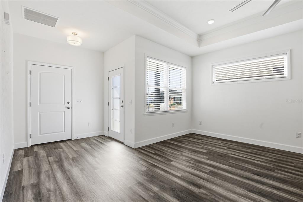 24302 Southwest 18th Road Newberry, FL 32669 - Photo 2 of 30 an empty room with wooden floor and windows