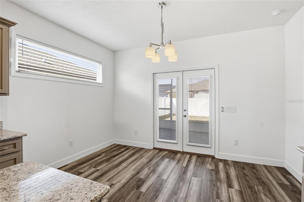 24302 Southwest 18th Road Newberry, FL 32669 - Photo 24 of 30 a view of wooden floor and a chandelier in a room