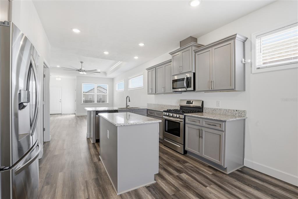 24302 Southwest 18th Road Newberry, FL 32669 - Photo 4 of 30 a kitchen with a sink stove and refrigerator
