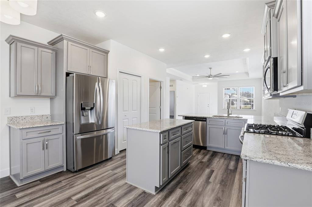 24302 Southwest 18th Road Newberry, FL 32669 - Photo 8 of 30 a kitchen with a refrigerator and a sink